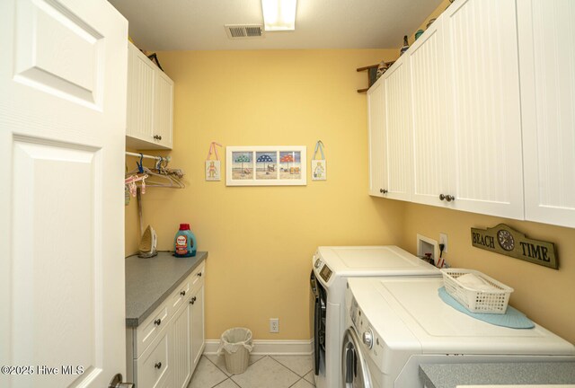 laundry area with cabinet space, visible vents, baseboards, independent washer and dryer, and light tile patterned flooring