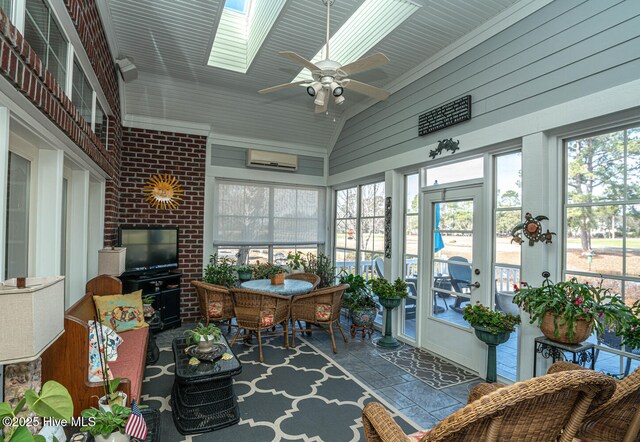 sunroom with lofted ceiling with skylight, a wall mounted air conditioner, and a ceiling fan