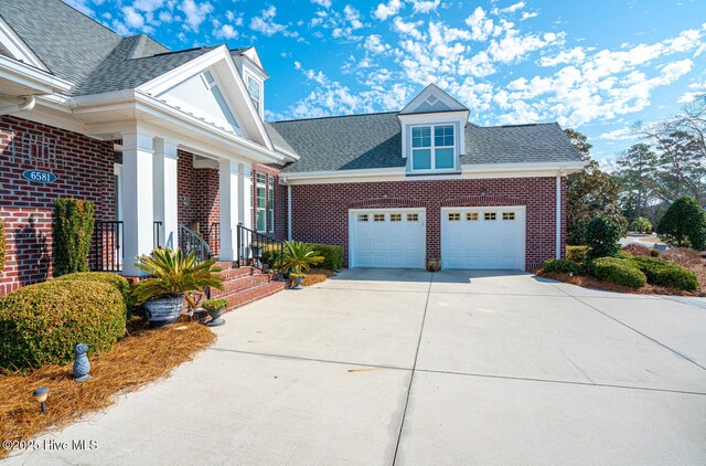 view of property exterior featuring an attached garage, roof with shingles, and brick siding