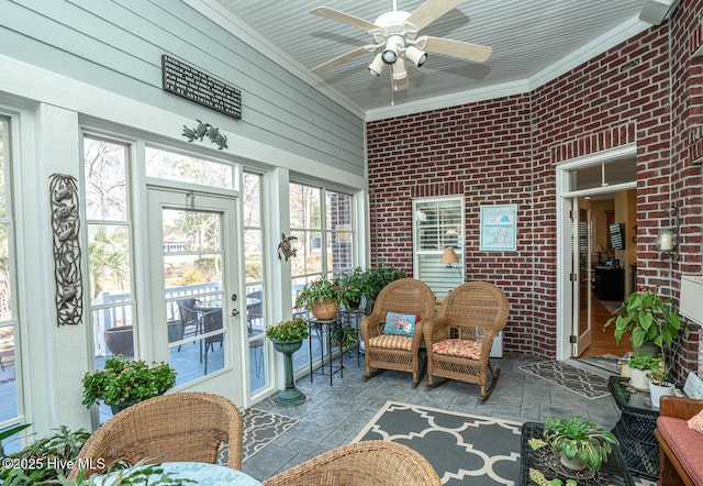 sunroom featuring a ceiling fan