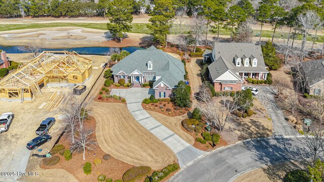 birds eye view of property with view of golf course and a residential view