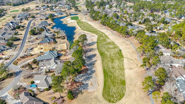 aerial view featuring golf course view, a water view, and a residential view