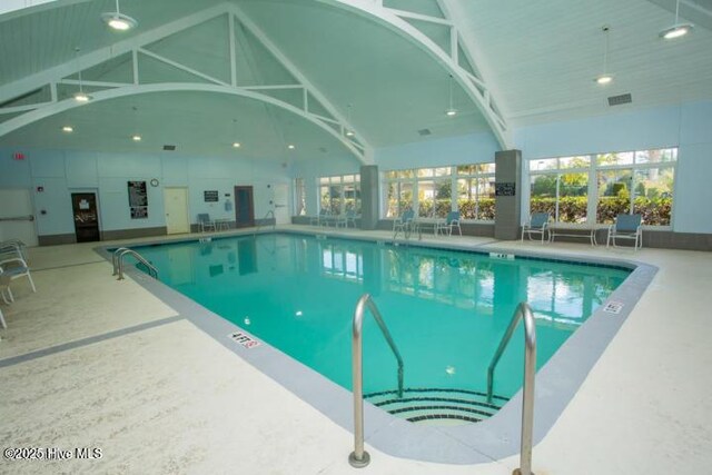 exercise room featuring wood ceiling, visible vents, ceiling fan, and a tray ceiling