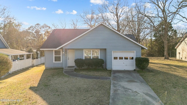 view of front of house with a garage, concrete driveway, roof with shingles, fence, and a front lawn