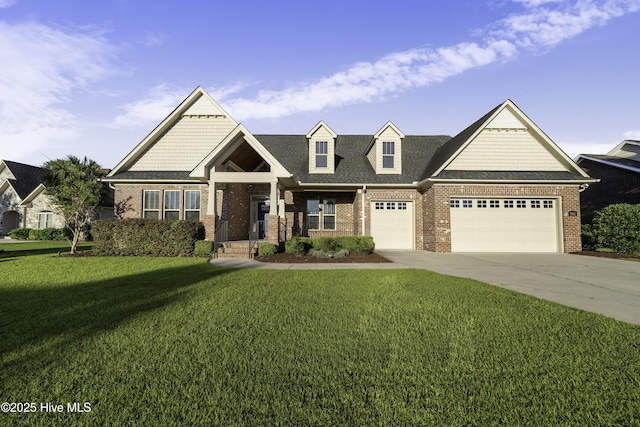 view of front of property featuring a front yard, concrete driveway, brick siding, and an attached garage