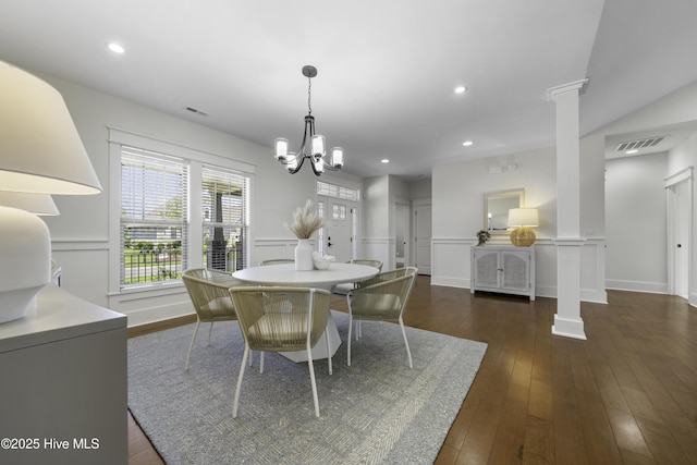 dining room featuring decorative columns, a chandelier, dark wood-type flooring, and recessed lighting