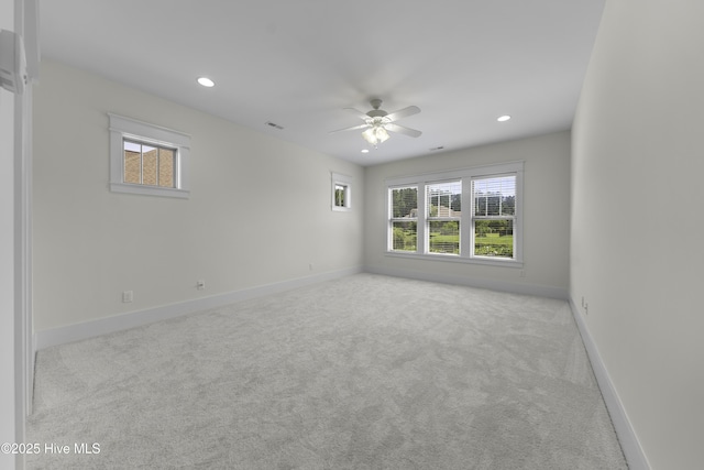 unfurnished room featuring a healthy amount of sunlight, baseboards, carpet floors, and recessed lighting