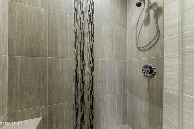 bathroom with tiled shower