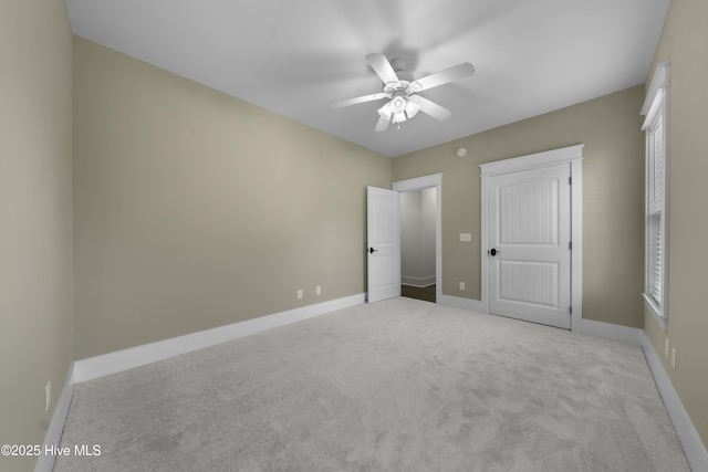 unfurnished bedroom with carpet, ceiling fan, and baseboards