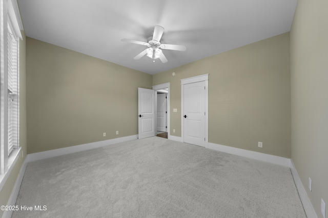 unfurnished bedroom with carpet floors, ceiling fan, and baseboards