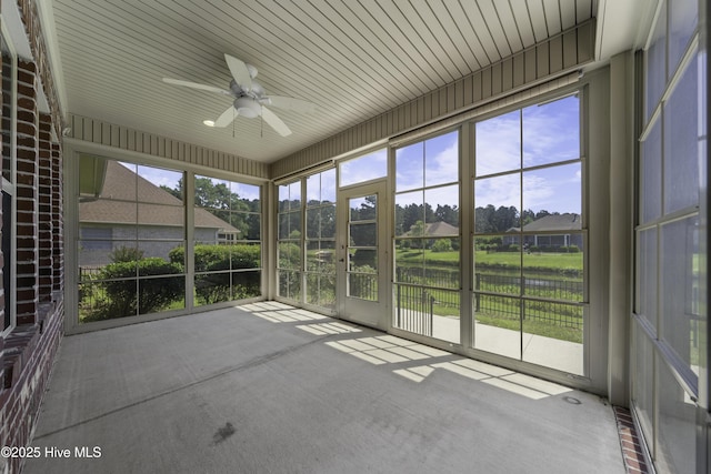 unfurnished sunroom with a ceiling fan