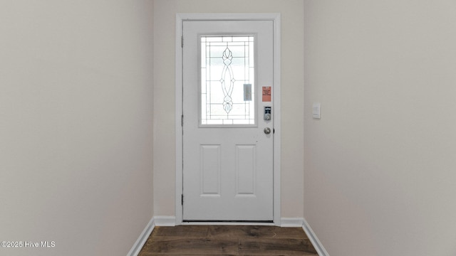 doorway to outside with dark wood-style floors and baseboards