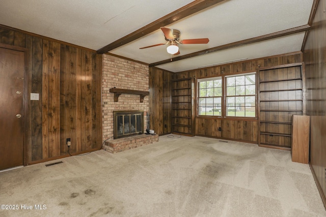204 Columbia Dr, Jacksonville, NC 28546 - unfurnished living room featuring carpet, visible vents, wood walls, and beamed ceiling
