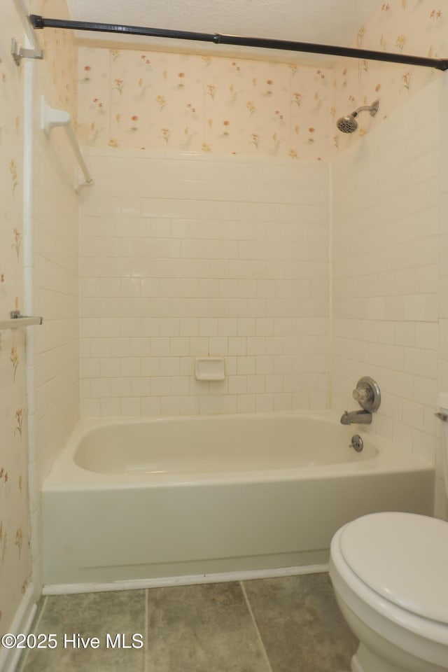204 Columbia Dr, Jacksonville, NC 28546 - bathroom with wallpapered walls, toilet, tile patterned flooring, and  shower combination