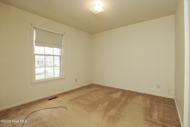 204 Columbia Dr, Jacksonville, NC 28546 - carpeted spare room featuring baseboards, visible vents, and a textured ceiling