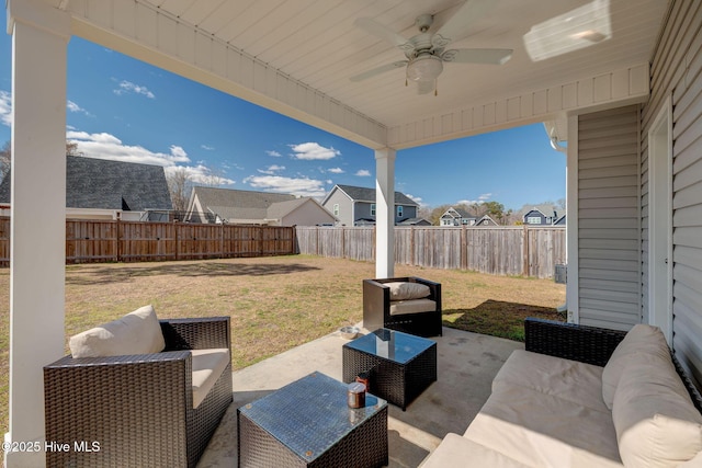 view of patio featuring a residential view, a ceiling fan, outdoor lounge area, and a fenced backyard