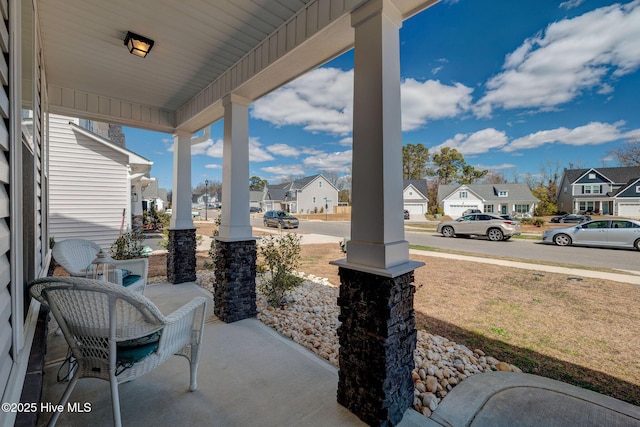 view of patio / terrace with a porch and a residential view