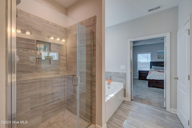 bathroom with a bath, visible vents, a stall shower, and ensuite bathroom