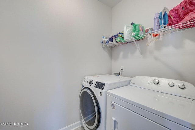 laundry room with laundry area, washer and dryer, and baseboards