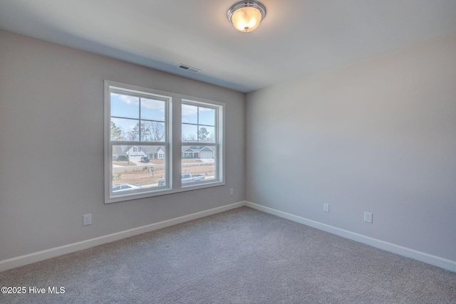 carpeted empty room with baseboards and visible vents