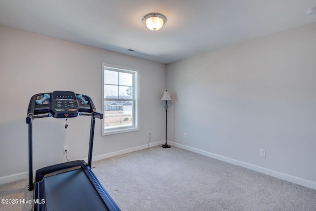 exercise room with carpet flooring, baseboards, and visible vents