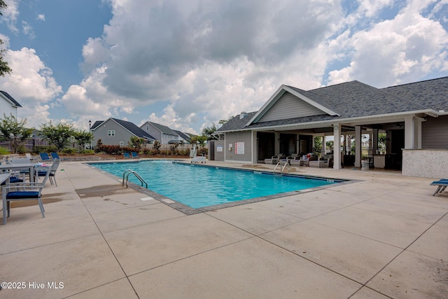 pool featuring a patio and fence