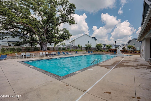 community pool featuring a patio area and fence