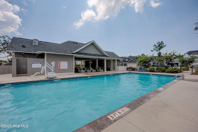 community pool featuring a patio and fence