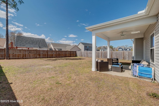 view of yard with a residential view, a patio, a ceiling fan, and fence