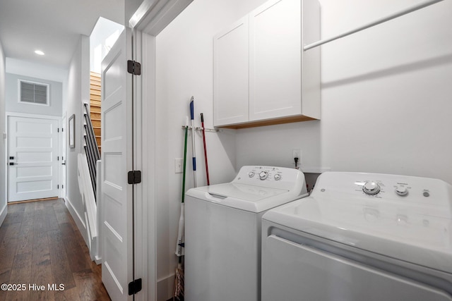 clothes washing area featuring visible vents, baseboards, cabinet space, dark wood-style flooring, and washer and dryer