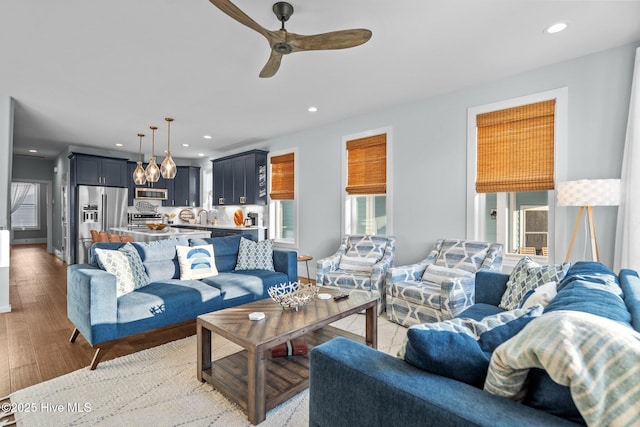 living room featuring recessed lighting, light wood-style floors, and a ceiling fan