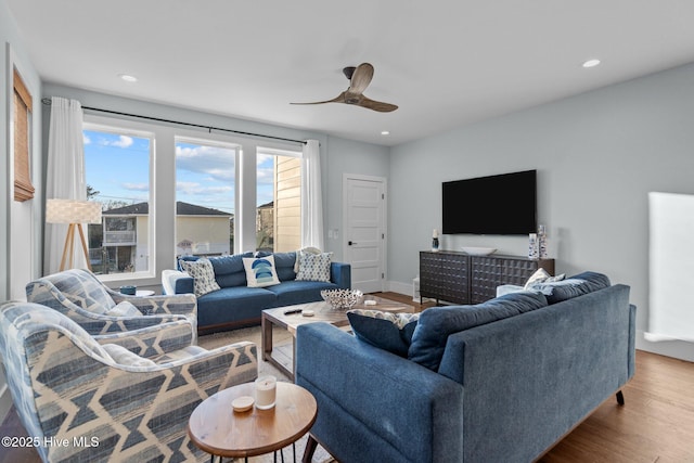 living area with a ceiling fan, recessed lighting, wood finished floors, and baseboards