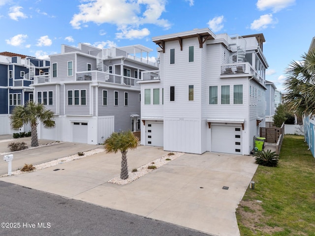 view of front of property featuring concrete driveway and an attached garage