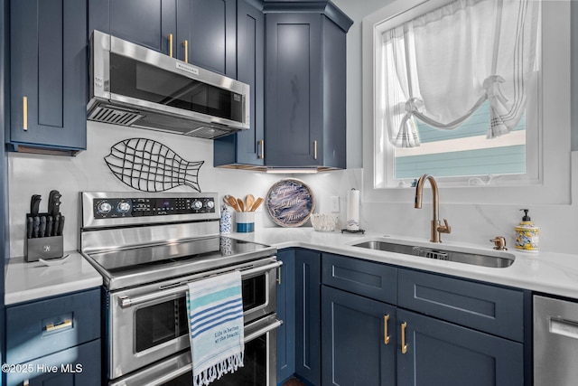 kitchen featuring a sink, blue cabinets, and appliances with stainless steel finishes