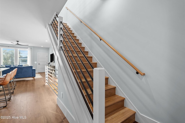 stairs with recessed lighting, baseboards, ceiling fan, and wood finished floors