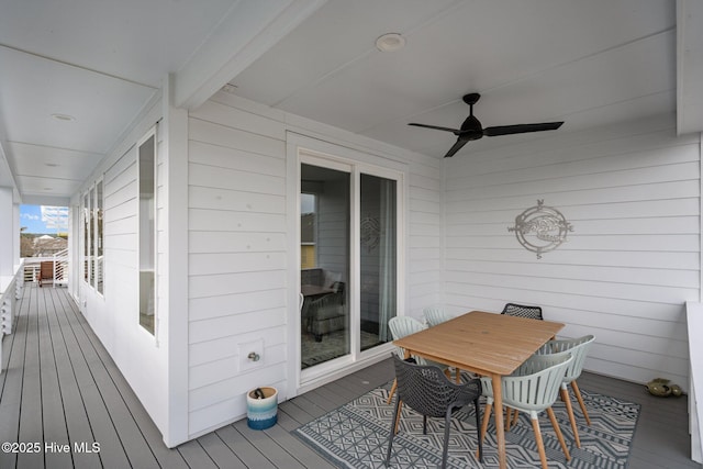 wooden deck with a ceiling fan