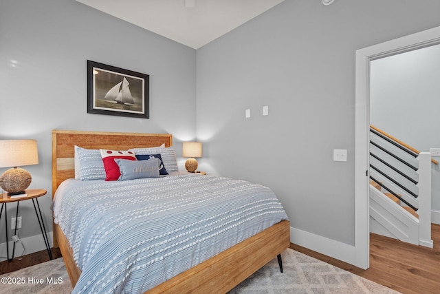 bedroom featuring baseboards and wood finished floors