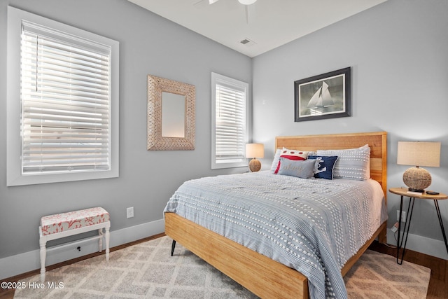 bedroom featuring visible vents and baseboards