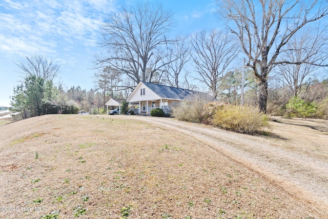 view of front of home featuring driveway and a porch