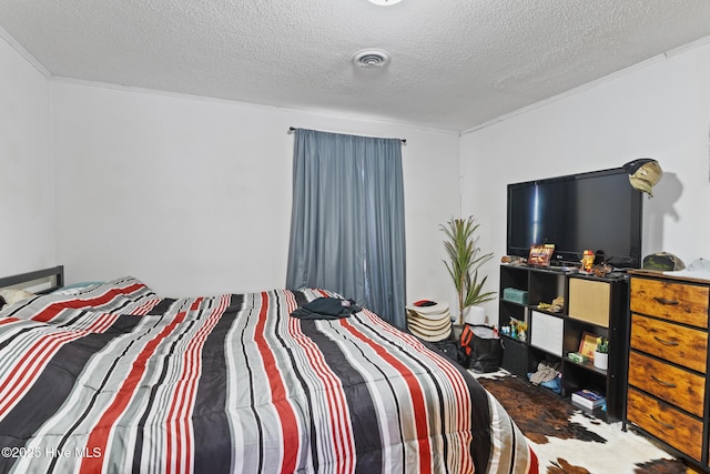 bedroom with visible vents and a textured ceiling