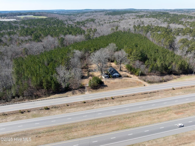 drone / aerial view featuring a view of trees