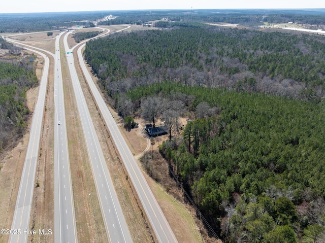 aerial view featuring a wooded view