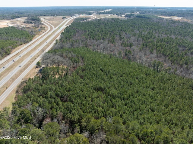 birds eye view of property featuring a wooded view