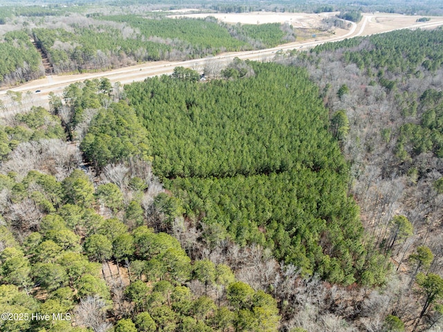 birds eye view of property with a forest view