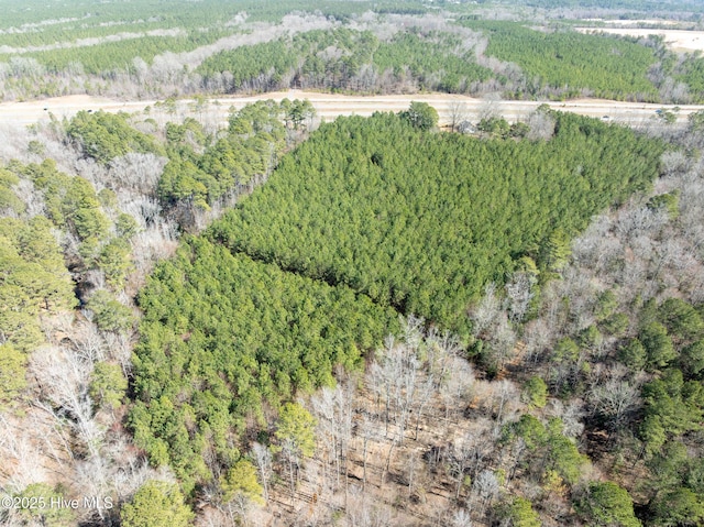 aerial view featuring a wooded view