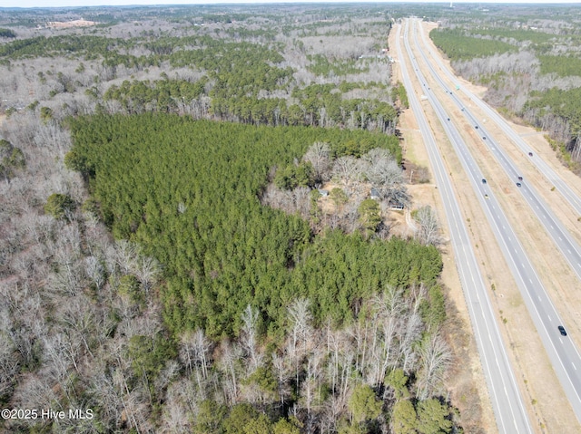 birds eye view of property featuring a view of trees