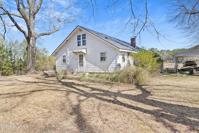 back of property featuring a chimney