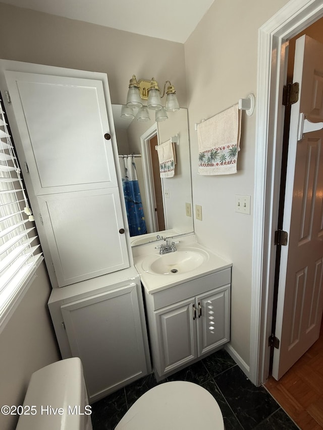 full bathroom featuring vanity and toilet