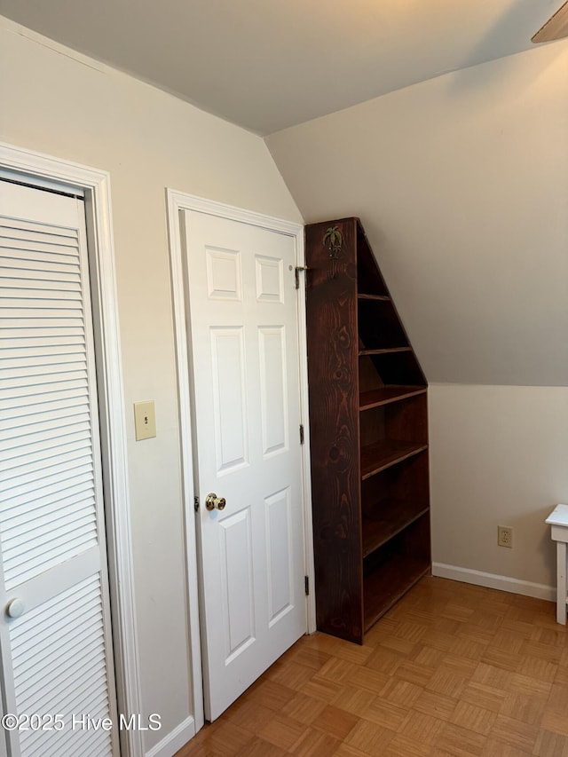 bonus room featuring vaulted ceiling and baseboards