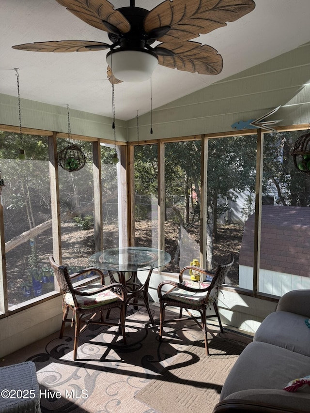 sunroom / solarium featuring lofted ceiling and a ceiling fan